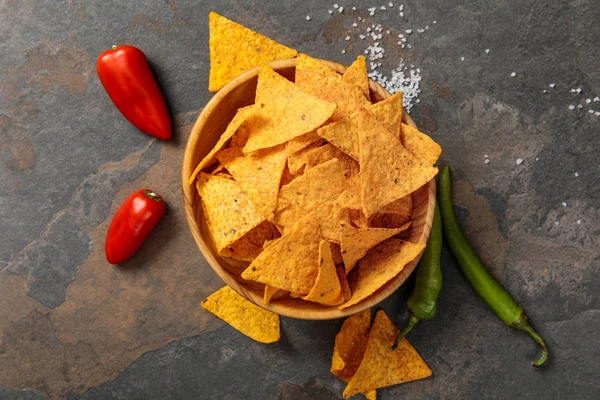 Top view of Mexican nachos served jalapenos and salt on stone table — Stock Photo