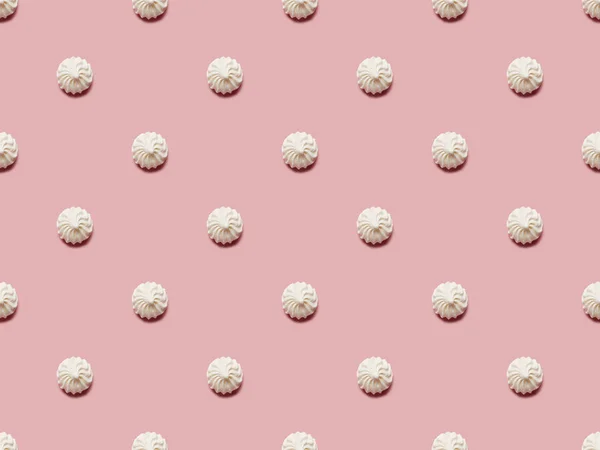 Flat lay with small white meringues on pink background — Stock Photo