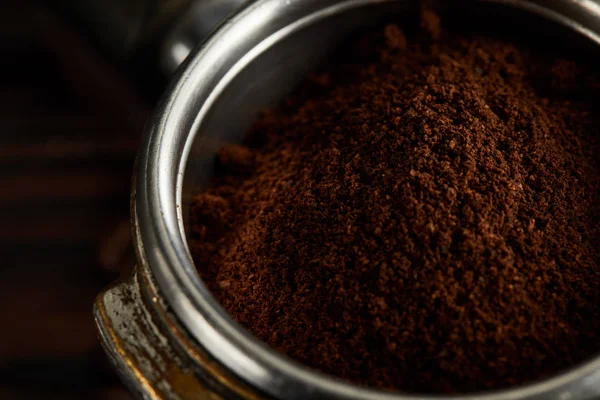 Metallic part of portafilter filled with fresh ground coffee — Stock Photo