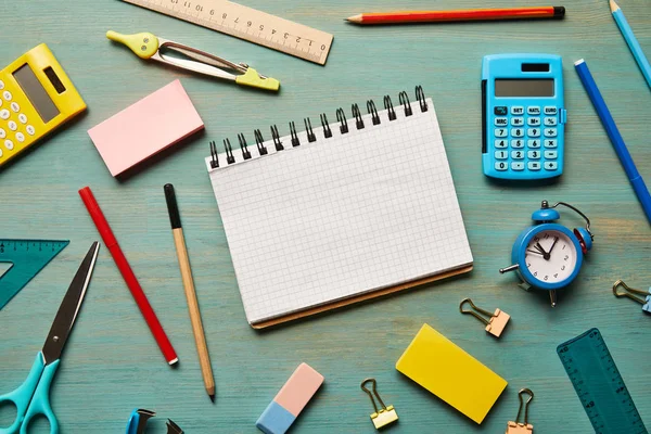 Top view of notebook with copy space near school supplies at wooden table — Stock Photo