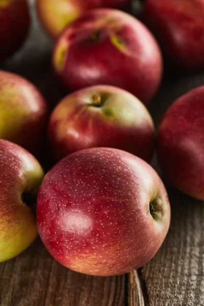 Red juicy apples on brown wooden surface — Stock Photo