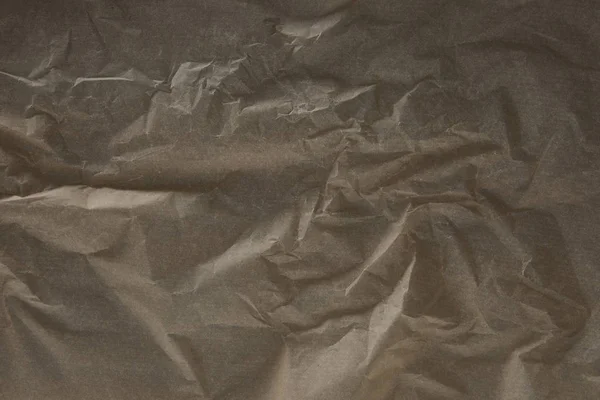 Top view of dark beige wrinkled parchment paper surface with copy space — Stock Photo