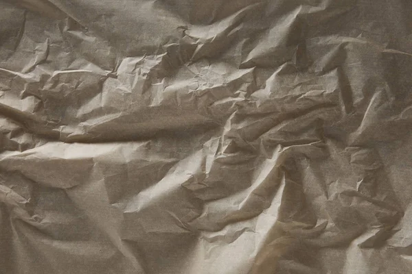 Vue de dessus de la surface de papier parchemin plissé beige avec espace de copie — Photo de stock