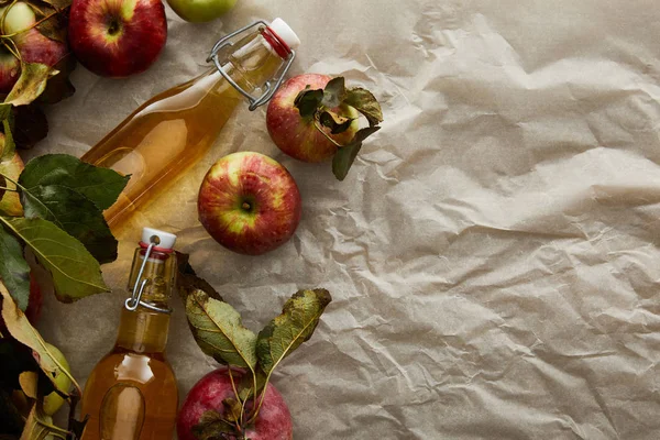 Top view of bottles with cider near apples with copy space — Stock Photo