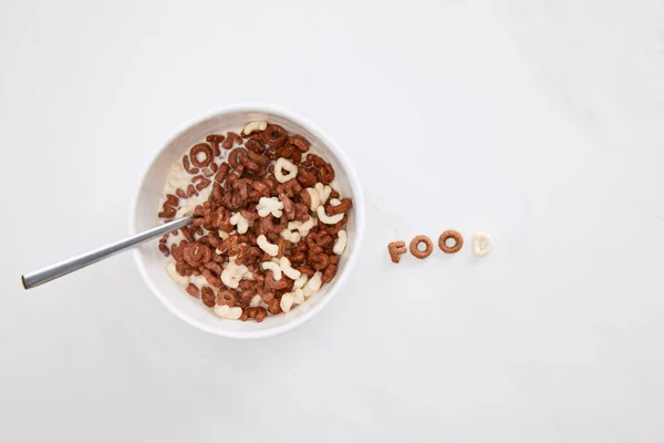 Top view of cereal food inscription near bowl on marble surface — Stock Photo