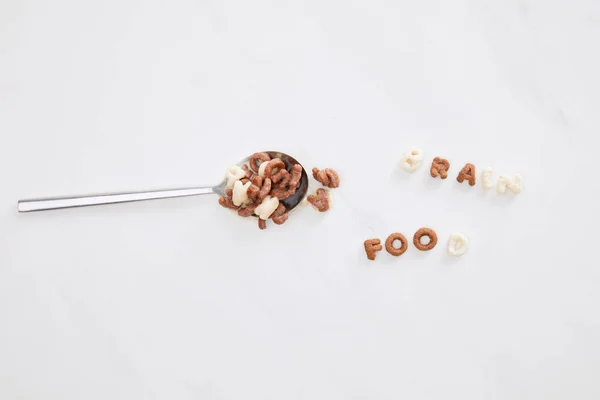 Vista superior de la inscripción de alimentos cerebrales de cereales cerca de cuchara en la superficie de mármol - foto de stock