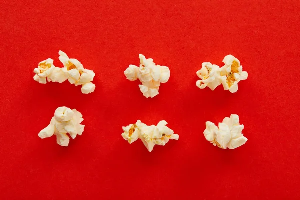 Flat lay with sweet popcorn on red background — Stock Photo