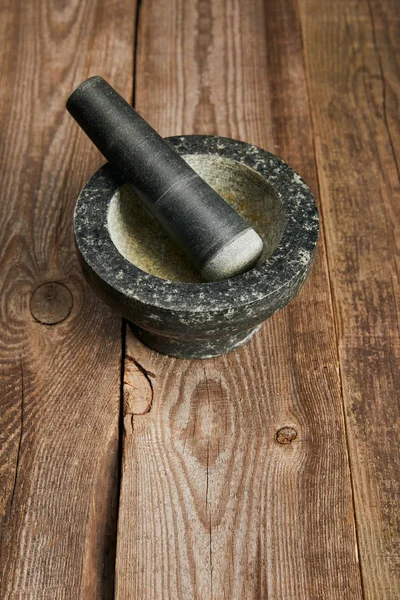 Argamassa de pedra cinza vazia na mesa de madeira marrom — Fotografia de Stock