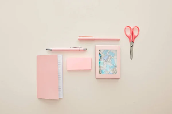Top view of pink stationery near box with paper clips isolated on beige — Stock Photo