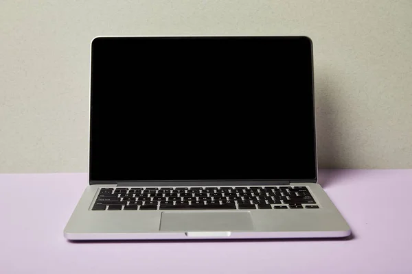 Laptop with blank screen on purple and grey — Stock Photo