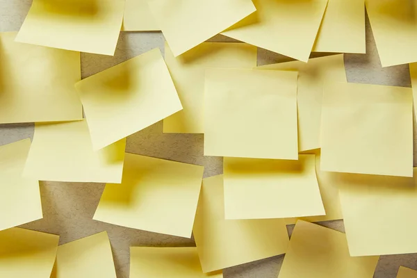 Blank yellow sticky notes on grey — Stock Photo