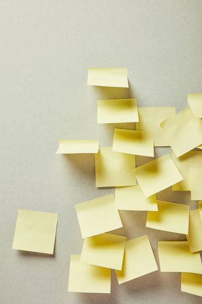 Blank and yellow sticky notes on grey — Stock Photo