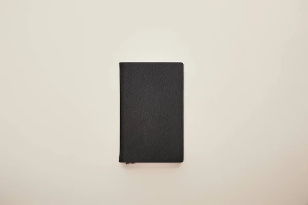 Top view of black notebook isolated on beige — Stock Photo