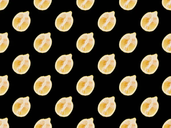 Background pattern with cut lemons isolated on black — Stock Photo