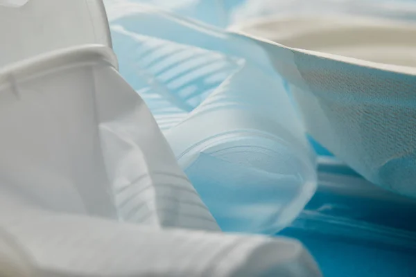 Close up view of crumpled plastic cups on blue background — Stock Photo