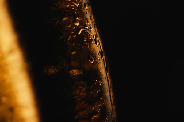 Close up view of water drops on glass bottles of beer isolated on black — Stock Photo