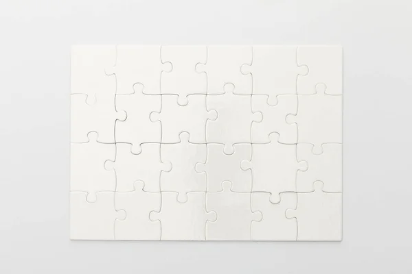 Top view of completed jigsaw puzzle on white background — Stock Photo