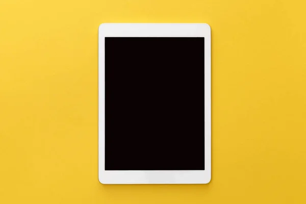 Top view of digital tablet with blank screen on yellow background — Stock Photo