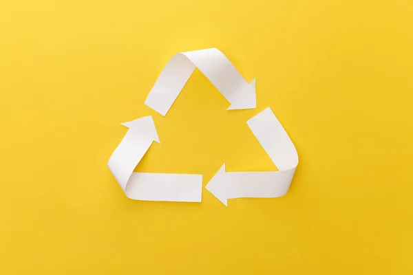 Top view of paper craft triangle on yellow background — Stock Photo