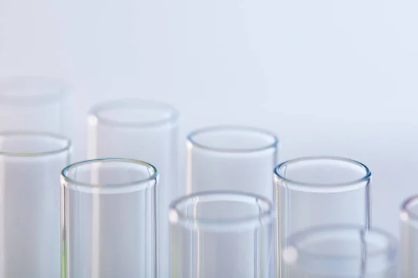 Vista de perto de tubos de ensaio de vidro isolados em branco — Fotografia de Stock