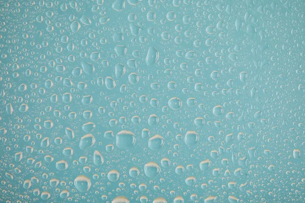 Clear transparent water drops on blue background — Stock Photo