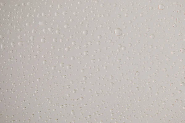 Clear transparent water drops on grey background — Stock Photo