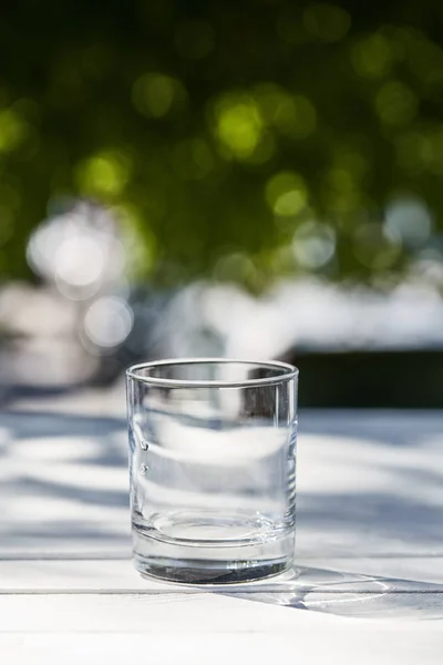 Fresh clean water in transparent glass at sunny day outside — Stock Photo