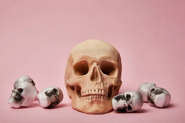 Spooky skulls on pink background, Halloween decoration — Stock Photo