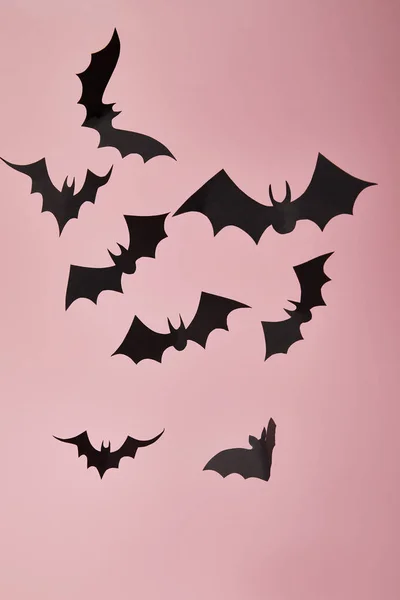 Black paper bats on pink background, Halloween decoration — Stock Photo