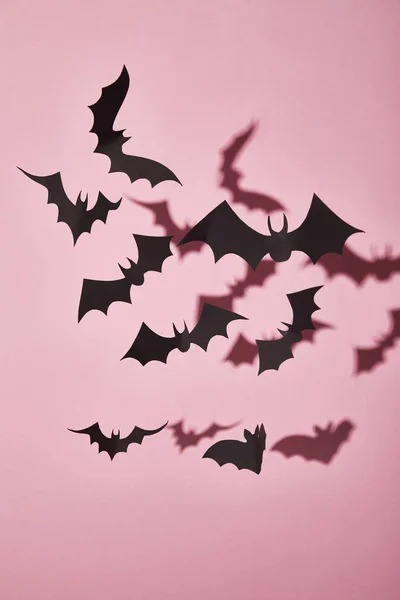 Black paper bats with shadow on pink background, Halloween decoration — Stock Photo