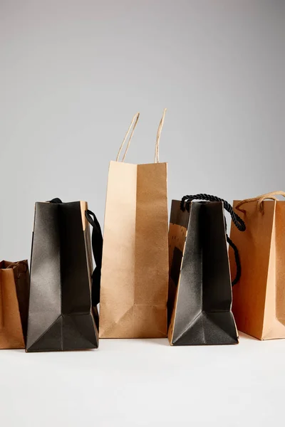 Paper shopping bags isolated on grey, black Friday concept — Stock Photo