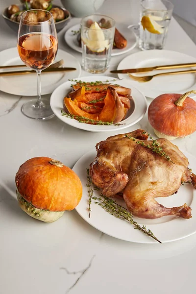 Grilled turkey and baked pumpkins served on white marble table — Stock Photo