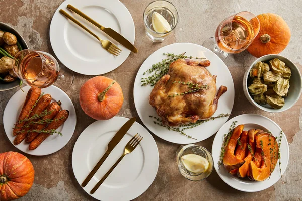 Top view of festive dinner with grilled turkey and baked vegetables served on stone surface — Stock Photo