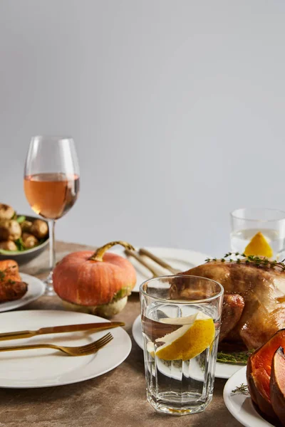 Whole pumpkin near grilled turkey, and glasses with rose wine isolated on grey — Stock Photo