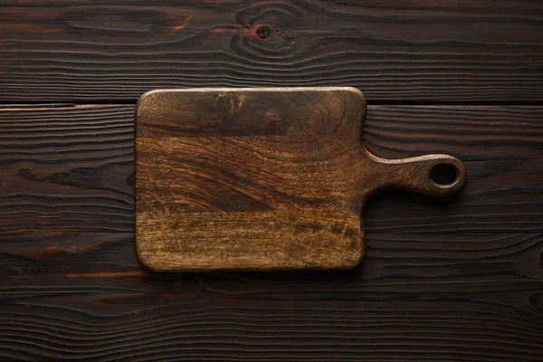 Top view of wooden and empty cutting board with copy space — Stock Photo