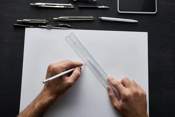Cropped view of architect drawing with pencil and ruler — Stock Photo