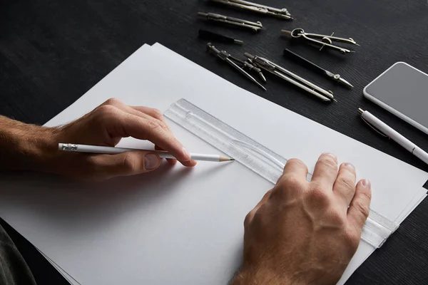 Cropped view of architect drawing with pencil and ruler — Stock Photo