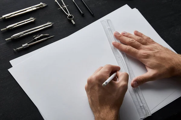 Cropped view of architect drawing with pencil and ruler — Stock Photo