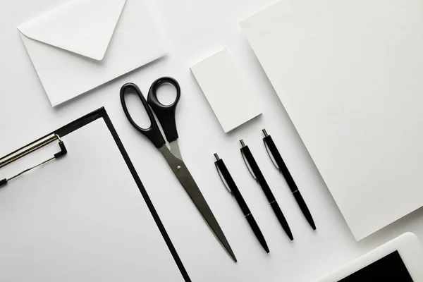 Top view of clipboard, pens, business card, paper, envelope, scissors and paper — Stock Photo