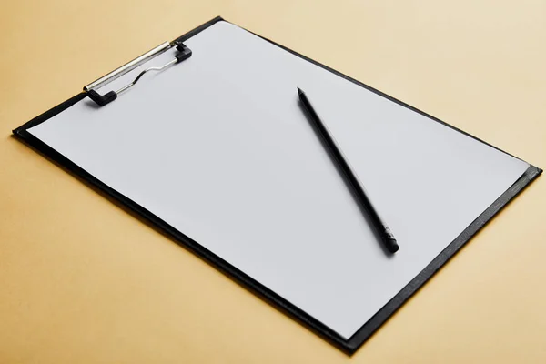 Clipboard with copy space and pencil on yellow background — Stock Photo