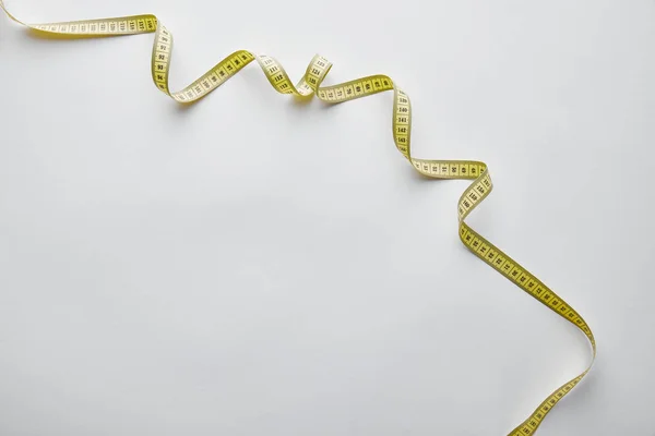 Top view of measuring tape on white with copy space — Stock Photo