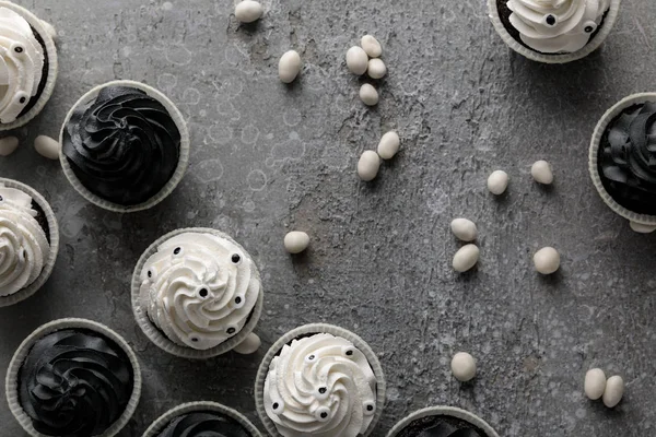 Top view of delicious Halloween cupcakes and sweets on concrete grey surface — Stock Photo