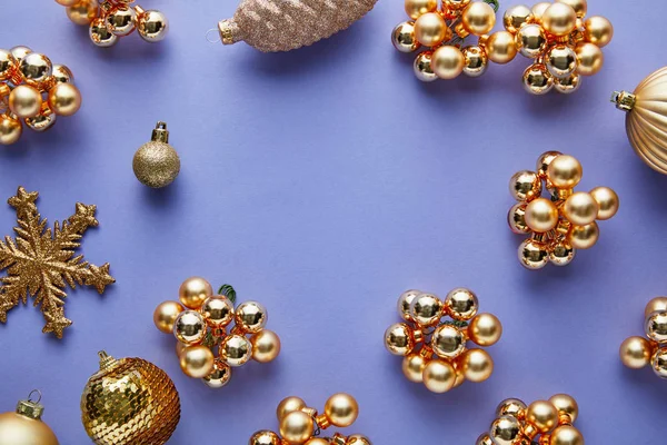 Top view of shiny golden Christmas decoration on blue background with copy space — Stock Photo