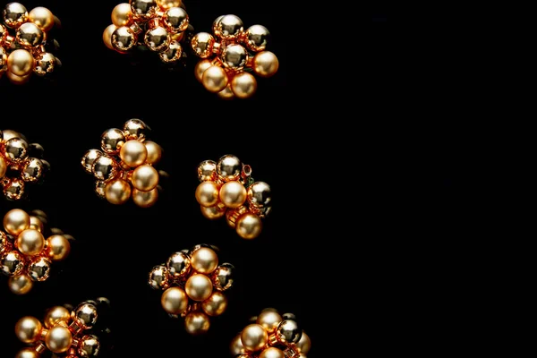 Top view of shiny golden Christmas decoration isolated on black with copy space — Stock Photo