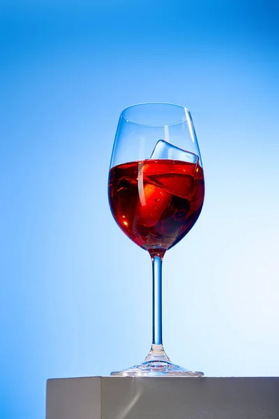 Cocktail Aperol Spritz with ice cubes in glass on blue background — Stock Photo
