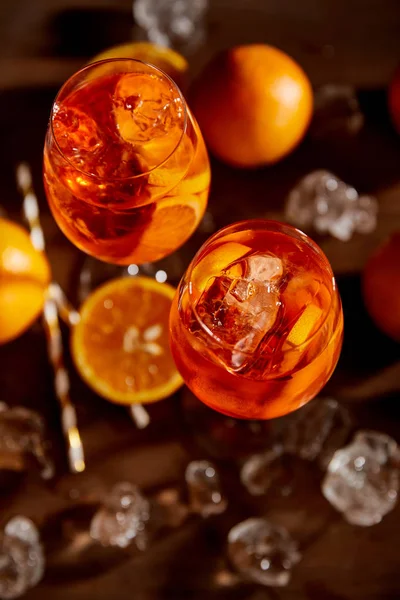 Vista dall'alto di Aperol Spritz in bicchieri, arance e cubetti di ghiaccio — Foto stock