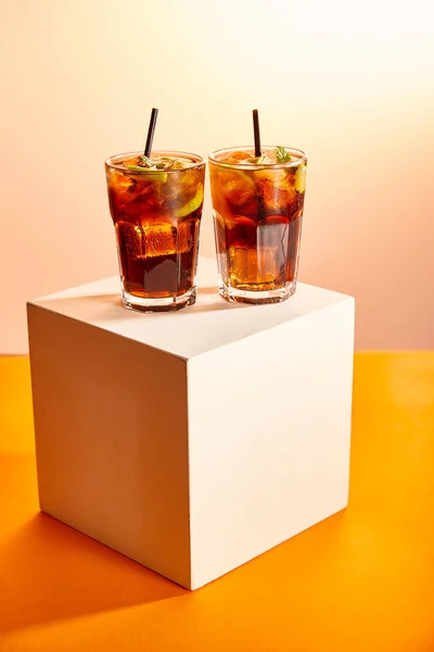 Cocktails cuba libre in glasses with straws on cube — Stock Photo