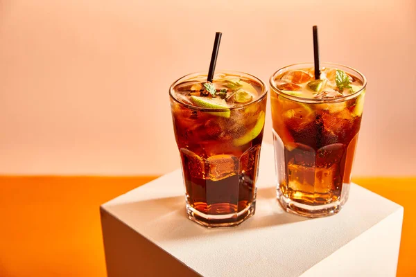 Cocktails cuba libre in glasses with straws on cube — Stock Photo