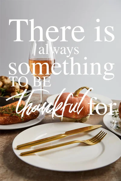 Plate with golden knife and fork near whole pumpkin and glass with rose wine isolated on grey with there is always something to be thankful for illustration — Stock Photo