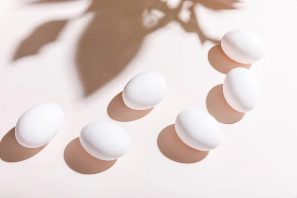 Boiled white chicken eggs for breakfast on grey table with shadows — Stock Photo